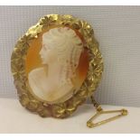 Cameo brooch set in decorative 9ct gold mount with safety chain.