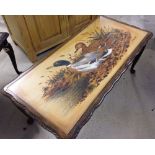 A rectangular coffee table with painted ducks under glass top 97cm x 48cm x 44cm tall.