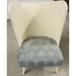 A vintage Lloyd Loom style curved back bedroom chair with blue upholstery and sprung seat