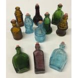 A box of 11 miniature coloured glass bottles.