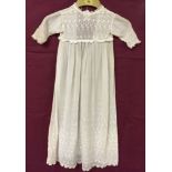 An Edwardian christening gown with shaped hem, embroidery to chest , sleeves and bottom.