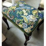 A vintage stool with parrots & flower upholstery.