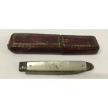 A vintage silver bladed fruit knife with mother of pearl handle in red leather case.