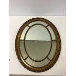 Vintage gilt framed oval mirror with beaded edge panels and leaf decoration to outside border.