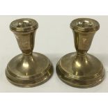 A pair of silver candle holders Birmingham 1993. Makers mark LJM. Filled 9cm tall.