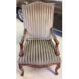 Vintage carved green striped upholstered armchair.