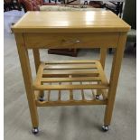 A pine kitchen utlity trolley with wine rack and shelf. 64 x 46cm top and 85cm tall.