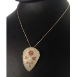 Enamelled shell pendant on a silver box chain.