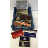 A mixed box of odds to include medals, military badges, coins, a kodak camera, 4 pens, etc.
