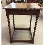 An oak side table with pie crust edge and barley twist legs. 50 x 50cm square.