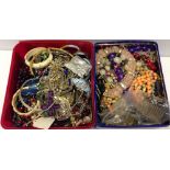 2 tubs of assorted costume jewellery.