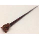 A vintage cane swagger stick with carved Boxer dog head finial.