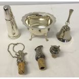 A small quantity of silver plated items to include 3 bottle stoppers, a pepperette, bell with