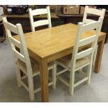 Pine kitchen table with 4 cream chairs with rush seats.