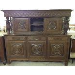 A solid oak traditional Breton buffet intricately carved with wheel design. 209cm, 6'10".