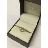 A 9ct gold ring set with a cluster of white stones. Size N½.