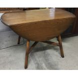 An Ercol oval drop leaf table.