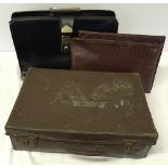 A vintage black briefcase with key, containing 2 faux crocodile skin document holders and a small