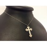 Silver cross on a chain.