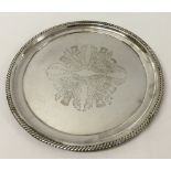 A silver plated Harrods circular tray 30cm diameter with thistle decoration to centre. In very