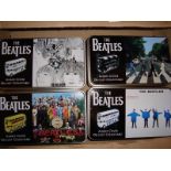A group of Corgi Routemaster Limited Edition buses in Beatles Album Cover liveries, and in