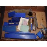 A tray of Hornby 3 rail track and transformer with some accessories. G-VG in F-G boxes where boxed.