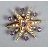 An Edwardian gold seed pearl and amethyst set star brooch.