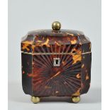 A George III tortoiseshell tea caddy of octagonal form, the front panel pressed with a sunburst