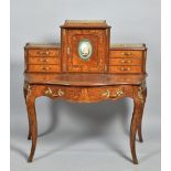 A 19c Louis XV style figured walnut bonheur du jour, the table of serpentine form, the gallery of