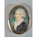 Early 19c English school - an oval portrait miniature of a young gentleman wearing a black coat