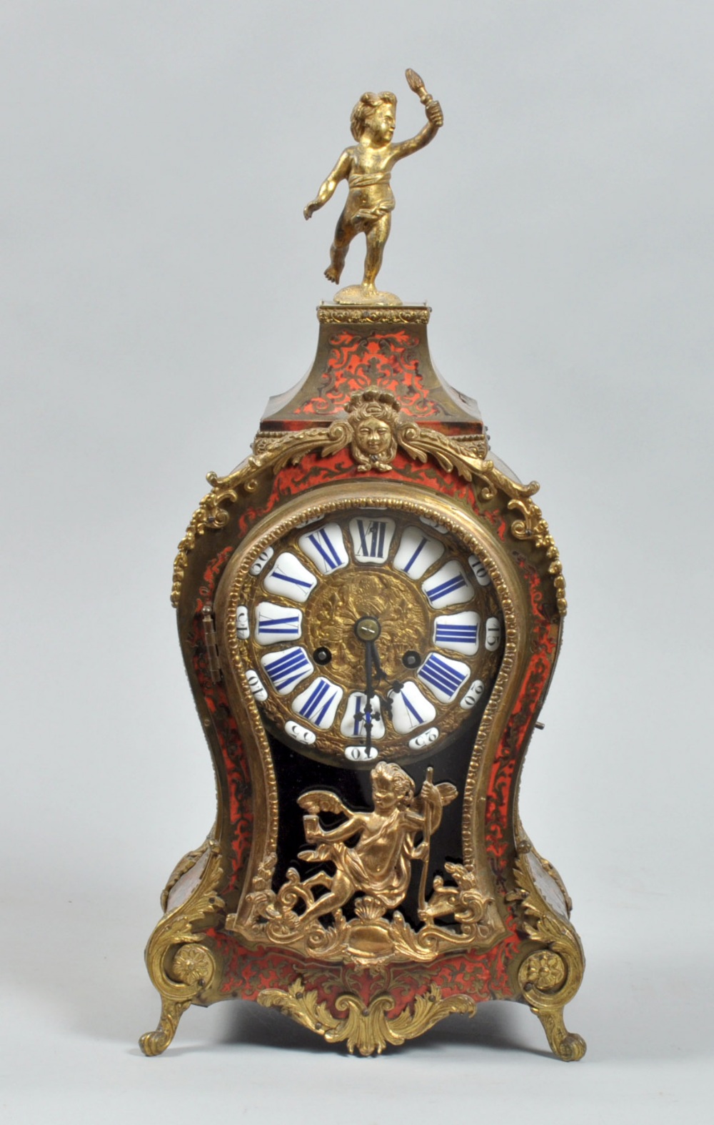A late 19c French mantle clock in waisted red boullework case with gilt brass feet and mounts,