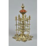 A Victorian brass cotton reel tower surmounted by a crowned pin cushion, the tower with spindles