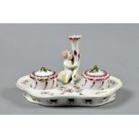 A 19c Vienna porcelain desk stand of scroll moulded form with two fitted recesses for inkwell and