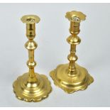 Two 18c brass petal based candlesticks, both double knopped and of similar design, 8"h.