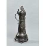 A 19c German pewter flagon decorated with heraldic crests, swag and crown, having a hinged domed