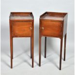 A pair of late Georgian mahogany pot cupboards with three quarter galleries, single hinged doors and
