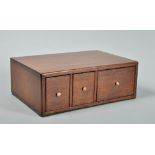 An early 19c mahogany table top cabinet fitted three short drawers, 12"w.