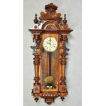 A late 19c German two weight Vienna regulator by Gustav Becker, the large and ornate walnut case