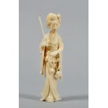 A Meiji period carved ivory figure of a lady with parasol in her right hand and holding a spray of