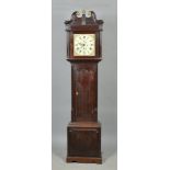 An early 19c eight day longcase clock with a 12" square brass dial having florally painted corners