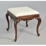 A mid Victorian rosewood stool, the moulded seat rails with shell and scroll carving and supported