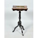 A Victorian ebonised pedestal tripod lamp table , the table top with stone inset surrounded by a