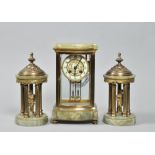 A late 19c French garniture de cheminee comprising a central four glass clock flanked by two