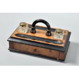 A Victorian walnut and ebonised two bottle inkstand fitted central carrying handle and with one