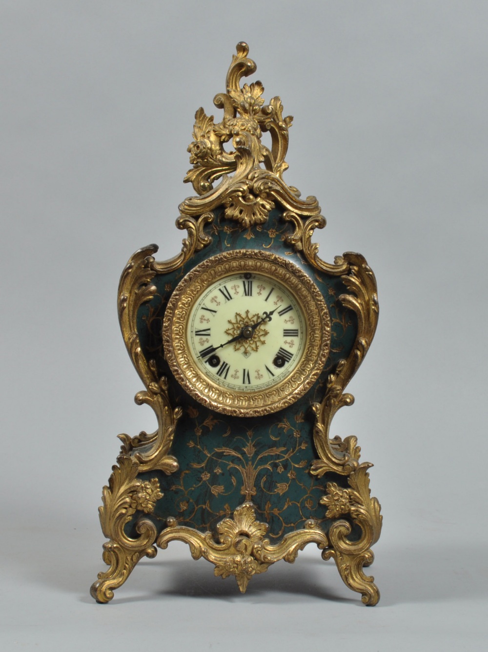 A late 19c American mantel clock by Ansonia in a waisted case of bakelite, florally engraved and