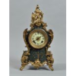 A late 19c American mantel clock by Ansonia in a waisted case of bakelite, florally engraved and