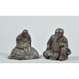 Two patinated and coppered Oriental figures , one seated on a shi-shi, one robed and kneeling,