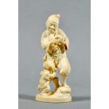 A Meiji period carved ivory figure group of a gentleman peeling an apple with child at foot, red