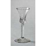 An 18c wine glass with a waisted trumpet bowl, on a clear twisted stem and circular base, a/f