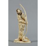 A Meiji carved ivory and inked figure of an archer, inscribed signature to base, 8.5"h.